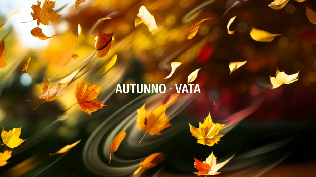 Foglie d’autunno gialle e arancioni trascinate dal vento, con la scritta Autunno · Vata